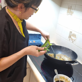 Person cooking with a wok