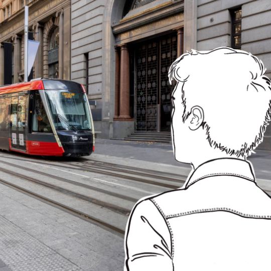 Photo of a tram approaching, a white cartoon cut-out figure is in the forground in from of the tram