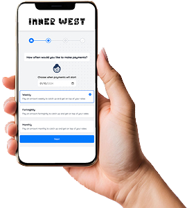 A hand holding a smartphone displaying a web page labeled 'Inner West'