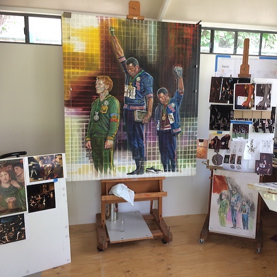 Photo of Miriam Cabello's studio showcasing the artwork Trinity Salute where Olympic athletes stand to receive medals giving the black power salute