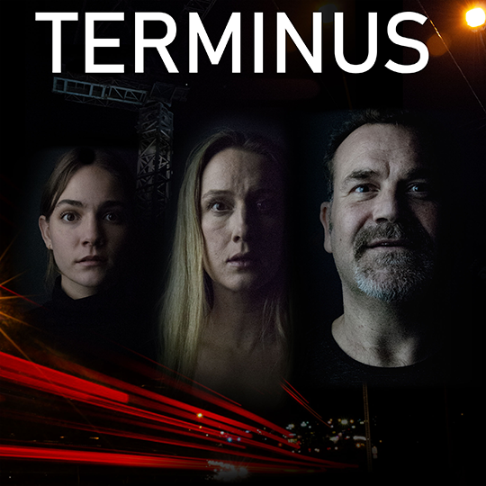 A black and white photo of three faces, with varying expressions, shock, disbelief and delight, the background is dark with a few things highlighted like some grey scaffolding on the top left and at the bottom just beyond the half way mark of the photo red beams of light shoot off diagonal lines across to the other half of the photo, the word Terminus is written in large font across the photo