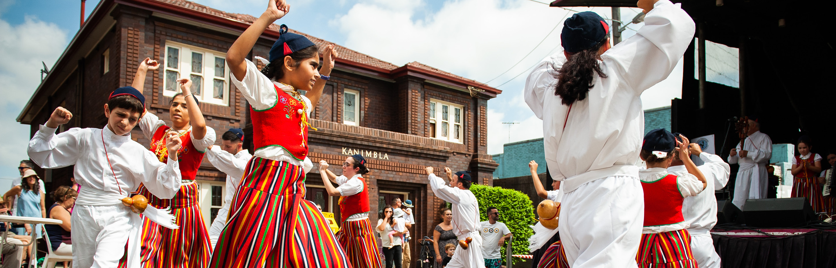 a group of people dancing in portuguese costume