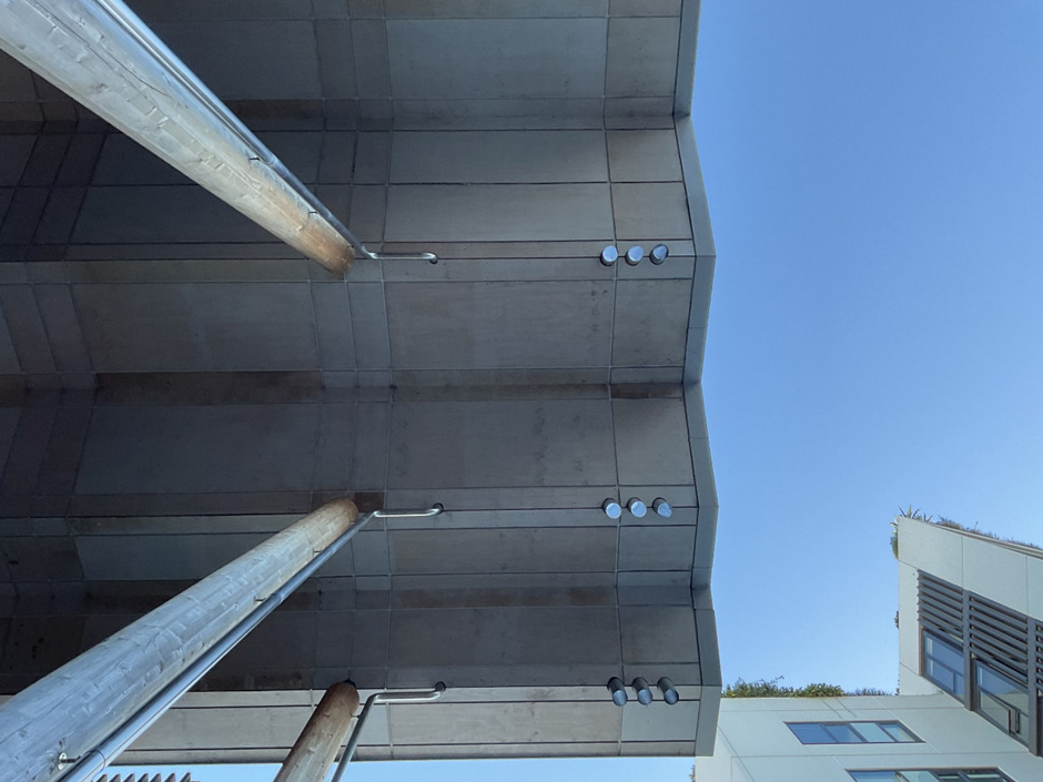 A dramatic view looking up at a tall serrated awning.