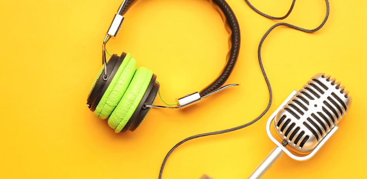 Microphone and earphones on yellow background