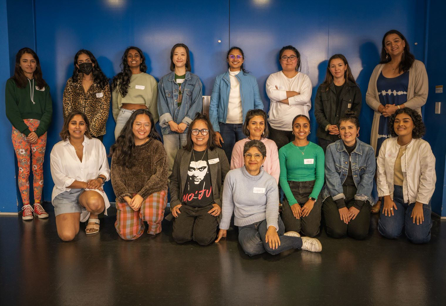 Diverse group of smiling women. Some wear COVID face masks.