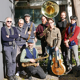 A group of musicians in a laneway