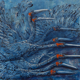 Blue artwork of a flock of birds with long beaks and red markings around their eyes