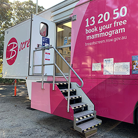 Pink and white van wiht the words "BScreen" written on it in cursive font. 132050 Book your free mammogram
