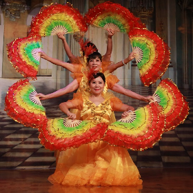 Perfromers holding rainbow coloured feather fans