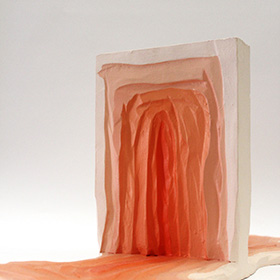 Sculpture of a doorway made of concentric organic pink and orange shapes