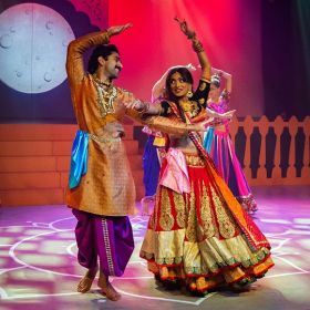 Two dancers in bright cultural dress