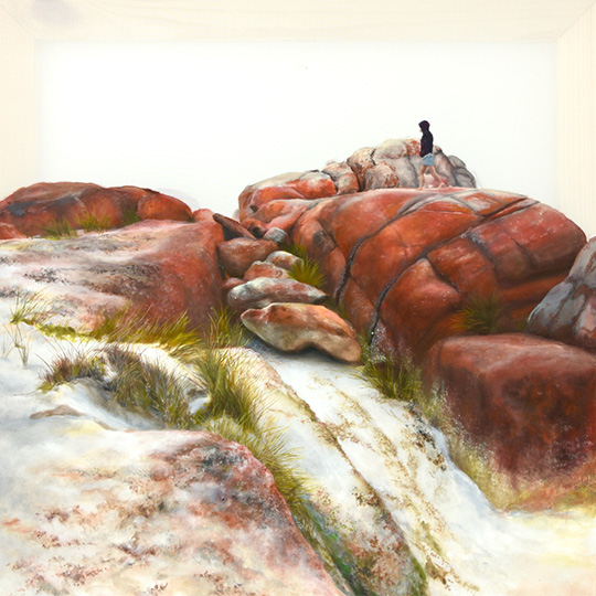 A person walking on a surreal rocky and grassy landscape.