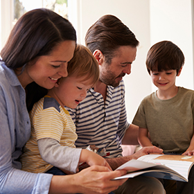 Family reading together at the library