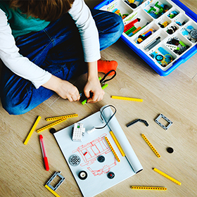 Little boy constructing a building