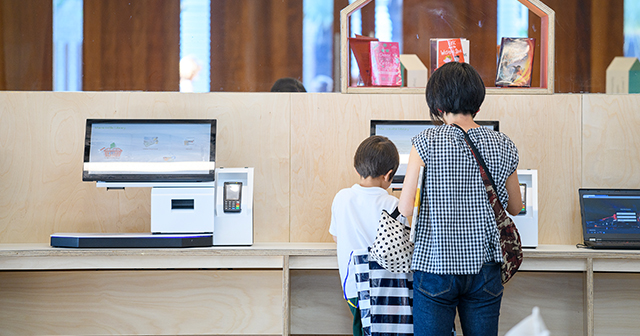 Mother and child borrowing a library book