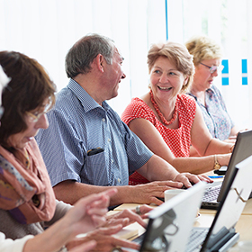 Senior adults learning in computer class