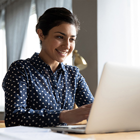 Smiling girl using a laptop