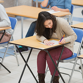 Students writing in the exam hall