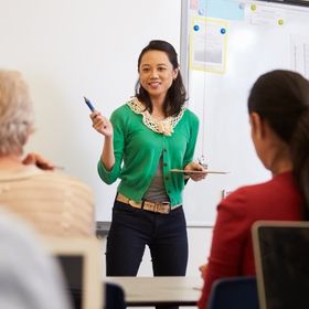 Teacher in front of students at an adult education class
