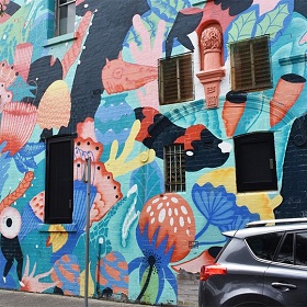 Photo of part of the Asylum Seekers Centre building featuring mural 