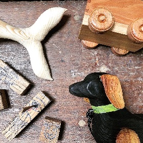 Photo of wood offcuts showing parts of wooden animals, cars and rectagles 