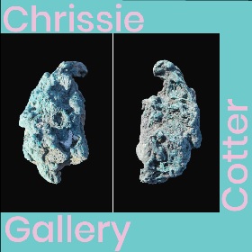 Light blue aqua rock looking object or icicle, the picture looks like it is mirrored and the same image is displayed next to the other, the picture is framed in an aqua frame with pink writing on the frame that read chrissie cotter gallery on each panel 