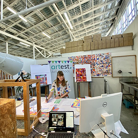 Photo of woman at Art Est Studio surrounding by art materials