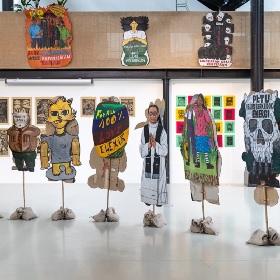 Photo of hand made puppet like paintings on stands - promotional Bersama exhibition image