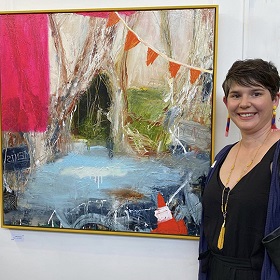 Photograph of artist Alexandra Plim standing in front of her winning Greenway Art Prize artwork painting of natural environment with human made pollution