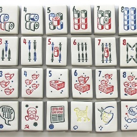 24 white mahjong like tiles are spread across photo the tiles have images green blue red and yellow of things like loo paper, masks, vaccinations