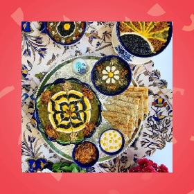 Photo of a table setting featuring Persian food that is highly decorative and styled with symmetry and strong lines, a number of small plates feature foods that have designs place ontpop of them like flowers and motifs