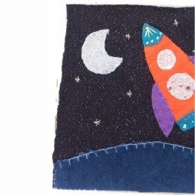 Patch of fabric with rocket design on it and star