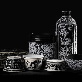 Set of black and white tableware looking objects like bottle, bowls, vases the items and black and white and quite striking with drippy like overlay design