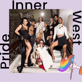 Group photo of Voguers on a white marble staircase, the group all look fabulous wearing black and white clothing and posing