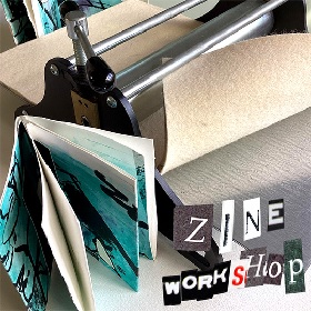 Photo of some kind of press with what looks like felt running through it, there is a folded aqua blue green book with some white pages sits upright standing with pages open. The cut out letters with various fonts and colours reads Zine Workshop