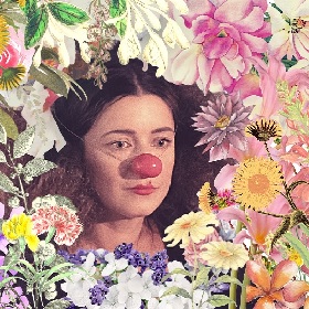 Clown face with red nose and sad expression is framed by a circular bounty of colourful flowers