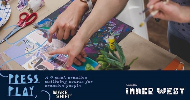 photo of hands creating artworks on a table, scissors, paint, paintbrushes