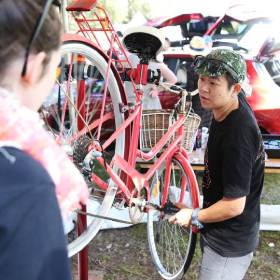 man working on red bike