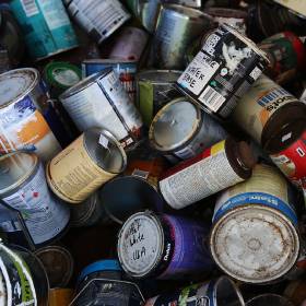 Many old paint tins on top of each other