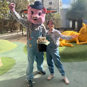 two people - one in pig costume for Patti the Pig shows