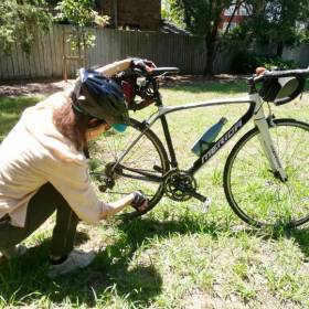 Woman checking her bike wheel