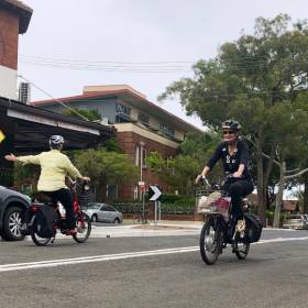 Two women cycling on a road
