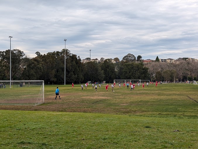 Soccer field with players on the pitch.
