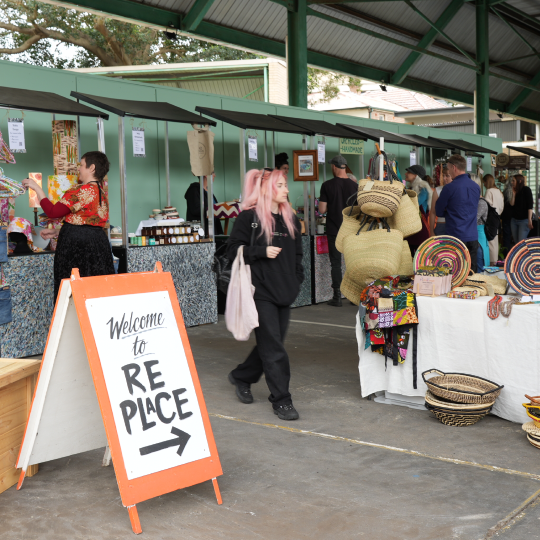 person with pink hair at a crowded market
