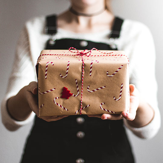 Woman handing over Christmas gift