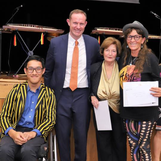 an image of award winners standing together while holding their certificates