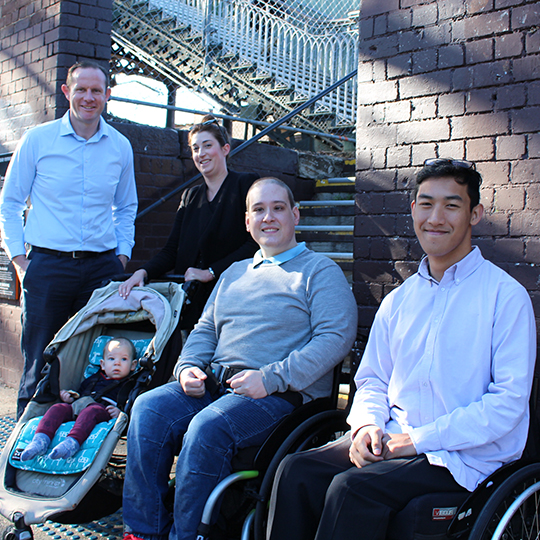 Darcy at Petersham Station with young-people in wheelchairs and a lady with a pram