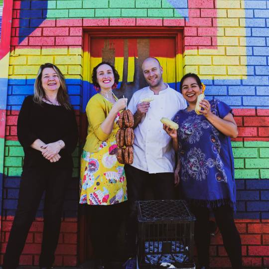 image of three women and a man standing in front of a colourful wall in Dulwich Hill