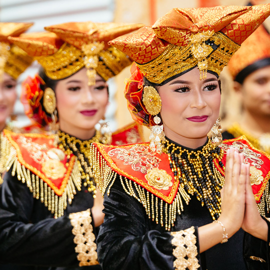 women wearing traditional cultural outfits celebrating an event