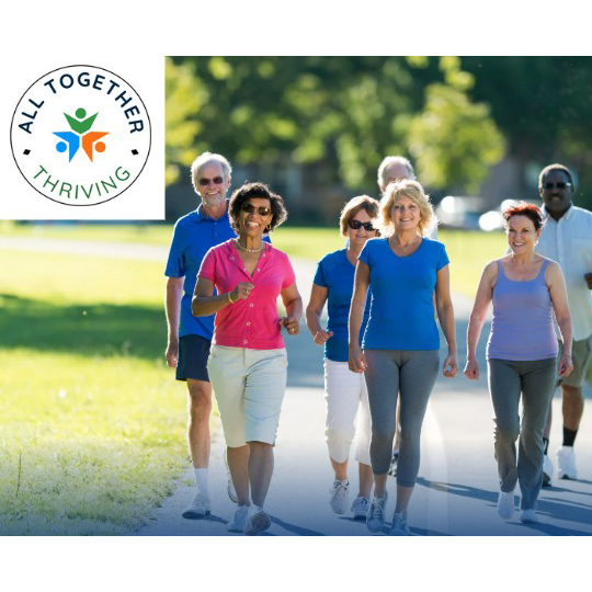 A walking group exercising in a park on a sunny day